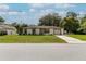 Charming single-story home with a manicured lawn, complemented by a long driveway leading to an attached garage at 9630 Eldridge Rd, Spring Hill, FL 34608