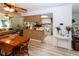 Kitchen and dining area featuring wood floors, appliances, and an island with barstool seating at 9630 Eldridge Rd, Spring Hill, FL 34608