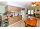 Open kitchen with wood floors and cabinets, overlooking the dining and living areas at 9630 Eldridge Rd, Spring Hill, FL 34608