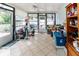 Enclosed lanai space with tile flooring, ceiling fan, and access to the backyard at 9630 Eldridge Rd, Spring Hill, FL 34608