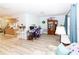 Open-concept living room featuring light wood floors, neutral walls, and ample natural light from large windows at 9630 Eldridge Rd, Spring Hill, FL 34608