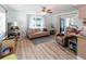 Inviting living room with wood-look floors, neutral sofa, and sliding glass doors to the lanai at 9630 Eldridge Rd, Spring Hill, FL 34608
