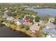 Scenic aerial shot of a home nestled among lush trees and near a serene lake with other homes nearby at 1010 Teal Pointe, Tarpon Springs, FL 34689