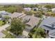 Aerial view of a well-maintained home with a lush, landscaped yard in a tranquil, pond-side community at 1010 Teal Pointe, Tarpon Springs, FL 34689
