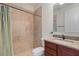 Tiled bathroom featuring a shower with a curtain rod, vanity with granite top, and toilet at 1010 Teal Pointe, Tarpon Springs, FL 34689