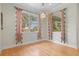 Sun-filled dining area features wood floors, chandelier, and bright windows at 1010 Teal Pointe, Tarpon Springs, FL 34689
