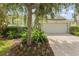 Charming single-story home with lush landscaping and a two-car garage and beautiful front yard at 1010 Teal Pointe, Tarpon Springs, FL 34689