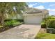 Beautiful one-story home with a two-car garage and nicely landscaped yard, and long driveway at 1010 Teal Pointe, Tarpon Springs, FL 34689