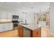 Updated kitchen features stainless appliances, granite countertops and a center island at 1010 Teal Pointe, Tarpon Springs, FL 34689