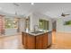 This bright, updated kitchen has a center island with granite countertops and stainless dishwasher at 1010 Teal Pointe, Tarpon Springs, FL 34689
