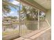 Screened lanai with tile flooring offering scenic views of the pond and surrounding greenery at 1010 Teal Pointe, Tarpon Springs, FL 34689