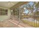 Screened lanai with tile flooring providing a beautiful view of the tranquil pond and landscape at 1010 Teal Pointe, Tarpon Springs, FL 34689