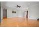 Hardwood floors throughout the spacious living room and dining area with fan and plenty of light at 1010 Teal Pointe, Tarpon Springs, FL 34689