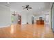 Bright and open living area with hardwood floors, kitchen view, and stylish furniture at 1010 Teal Pointe, Tarpon Springs, FL 34689
