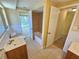 Bathroom features double sinks, tile flooring, and tub/shower combo at 10135 Glen Moor Ln, Port Richey, FL 34668