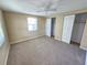 Bright bedroom with carpet flooring, a ceiling fan, and a window overlooking the yard at 10135 Glen Moor Ln, Port Richey, FL 34668
