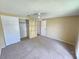 This bedroom features a large closet and neutral carpet at 10135 Glen Moor Ln, Port Richey, FL 34668
