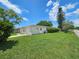 Side view of a single-story home with a well-manicured lawn and attached garage at 10135 Glen Moor Ln, Port Richey, FL 34668