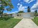 Charming single-story home with attached garage and a long concrete driveway at 10135 Glen Moor Ln, Port Richey, FL 34668