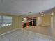 Open concept kitchen with wood cabinetry and black appliances at 10135 Glen Moor Ln, Port Richey, FL 34668