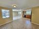 Bright, combined living and dining area with tile flooring and backyard views at 10135 Glen Moor Ln, Port Richey, FL 34668