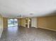 Spacious living room showcasing tiled floors, ceiling fans, and sliding glass doors at 10135 Glen Moor Ln, Port Richey, FL 34668