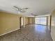 Open living area showcasing tiled floors, ceiling fans, and natural light at 10135 Glen Moor Ln, Port Richey, FL 34668