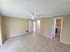 Spacious living room with tile floors and a ceiling fan offers a bright and airy atmosphere at 10135 Glen Moor Ln, Port Richey, FL 34668