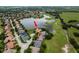 An aerial view of the property highlighting its position on a large pond in a lush and green area at 10342 Altrara Way, Trinity, FL 34655