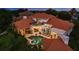 Back of house aerial view featuring an in-ground pool, a hot tub, and a second story balcony at 10342 Altrara Way, Trinity, FL 34655