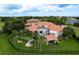 Stunning terracotta roof home featuring a private pool, outdoor living area, and a putting green in the lush backyard at 10342 Altrara Way, Trinity, FL 34655