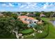 Expansive home featuring terracotta roof, lush landscaping, inviting pool area, and a putting green for recreation at 10342 Altrara Way, Trinity, FL 34655
