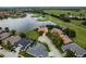 Aerial view of waterfront homes with terracotta roofs, set amidst lush landscaping and a beautiful golf course at 10342 Altrara Way, Trinity, FL 34655