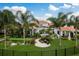 A well-maintained backyard with a putting green, in-ground pool, and palm trees at 10342 Altrara Way, Trinity, FL 34655