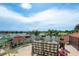 Serene balcony view overlooking a lake, golf course, and palm trees on a sunny day at 10342 Altrara Way, Trinity, FL 34655