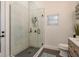 Modern bathroom featuring a glass shower with black accents and sleek fixtures at 10342 Altrara Way, Trinity, FL 34655