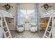 Bright bedroom with twin loft beds, cute decor, and a stylish window at 10342 Altrara Way, Trinity, FL 34655