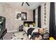 A cozy bedroom with a brick accent wall, gaming decor, and plush carpeting at 10342 Altrara Way, Trinity, FL 34655