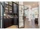 Elegant butler's pantry features dark cabinetry, marble countertops, and convenient access to other rooms at 10342 Altrara Way, Trinity, FL 34655