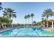 Beautiful community pool surrounded by palm trees and lounge chairs, perfect for relaxation and recreation at 10342 Altrara Way, Trinity, FL 34655