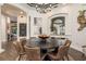 This dining room features a round dining table with seating and decorative artwork on the walls at 10342 Altrara Way, Trinity, FL 34655