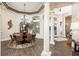 Bright dining room with a round table, decorative chandelier, and large windows for natural light at 10342 Altrara Way, Trinity, FL 34655