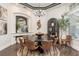 Elegant dining room features a round table, chandelier lighting, and decorative accents at 10342 Altrara Way, Trinity, FL 34655
