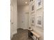 Hallway with tiled floors, neutral walls and decorative artwork at 10342 Altrara Way, Trinity, FL 34655