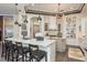Spacious kitchen with counter seating, modern appliances, a decorative island, and an open layout at 10342 Altrara Way, Trinity, FL 34655