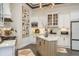 Modern kitchen with white cabinetry, marble countertops, stainless appliances, and a central island at 10342 Altrara Way, Trinity, FL 34655