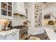 This kitchen showcases a stainless steel range, custom hood, and granite counters for a luxurious feel at 10342 Altrara Way, Trinity, FL 34655