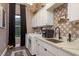Modern laundry room featuring designer wallpaper and front load machines at 10342 Altrara Way, Trinity, FL 34655