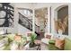 Elegant living area with tall columns, a wrought-iron staircase, and comfortable seating arrangements at 10342 Altrara Way, Trinity, FL 34655