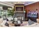 Stylish living room with a modern fireplace, aquarium, and large windows providing ample light at 10342 Altrara Way, Trinity, FL 34655